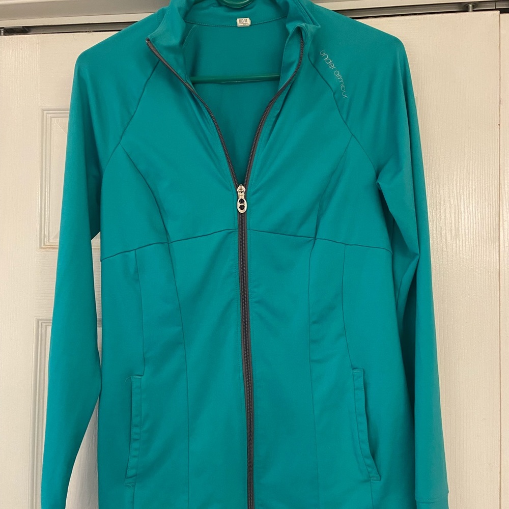 Ladies Under Armour zip up jacket. Teal in color